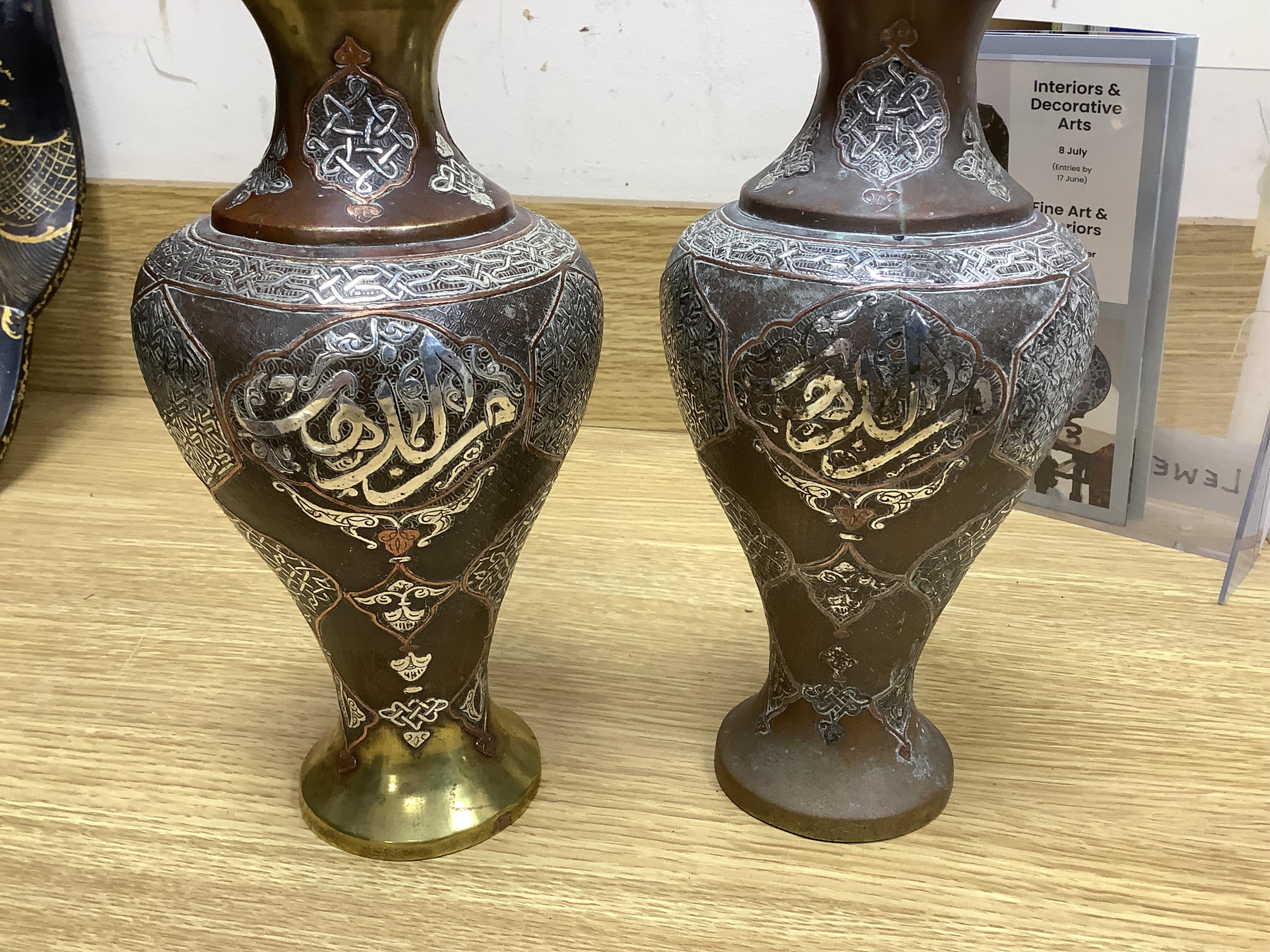 A pair of Cairoware silver and copper inlaid brass vases, 24cm high